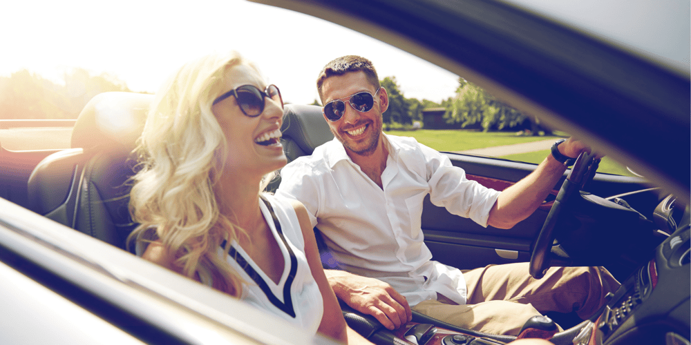 Stock Image of Young Couple in Luxury Car