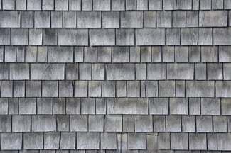 Siding of gray wood shingles with low environmental impact on house in Cape Cod, Massachusetts