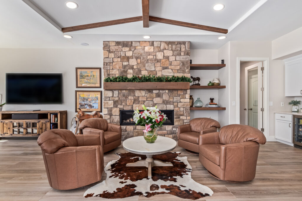 Modern living room with custom stone fireplace wall and built-in shelves