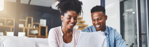 Couple reviewing paperwork deciding to remodel their home