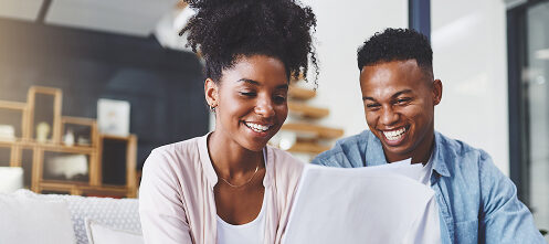 Couple reviewing paperwork deciding to remodel their home