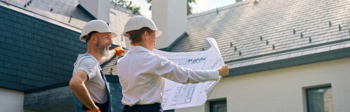 Construction workers planning their work with a blueprint outside a Scottsdale, AZ home
