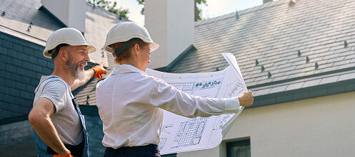 Construction workers planning their work with a blueprint outside a Scottsdale, AZ home