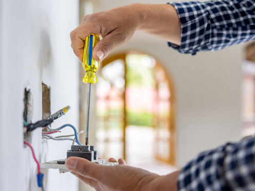 Person installing electrical outlet in beautiful home