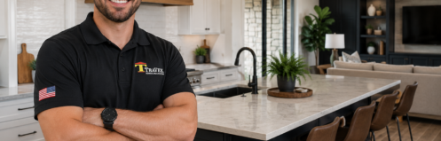TRAVEK lead carpenter standing in a completed kitchen remodel showcasing the design-build remodeling process